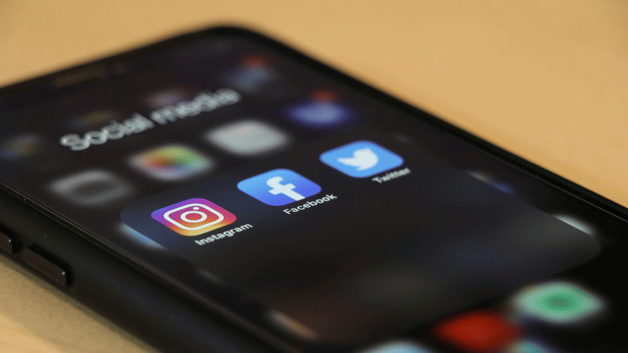A smartphone screen displaying a folder of social media apps, including Instagram and Facebook.