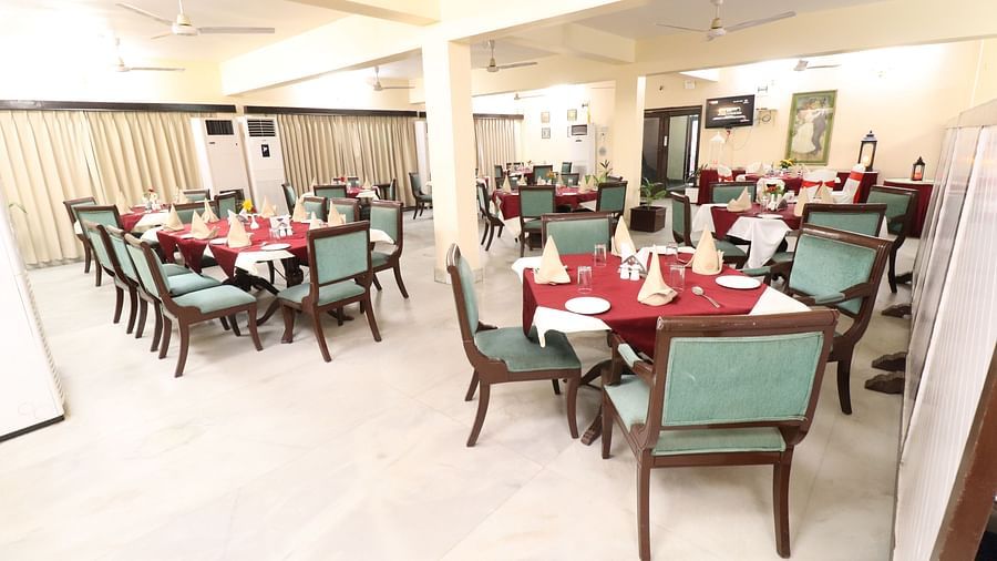  Light House Restaurant dining area set with tables, chairs, and cutlery, all prepared for a delightful meal.