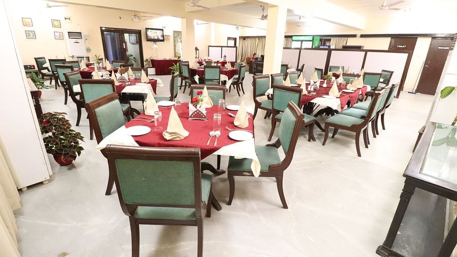  Light House Restaurant dining area set with tables, chairs, and cutlery, all prepared for a delightful meal.