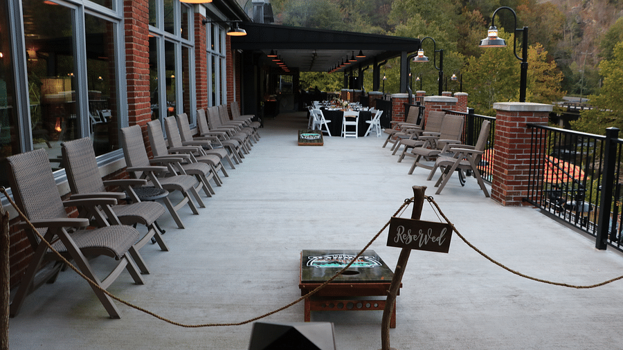 a reserved section at our resort for a wedding reception with well arranged dining area at the far end - Historic Tapoco Lodge