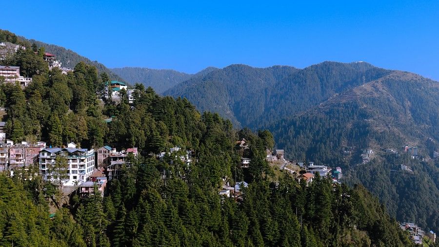 View of a town with mountain backdrop on a bright sunny day
