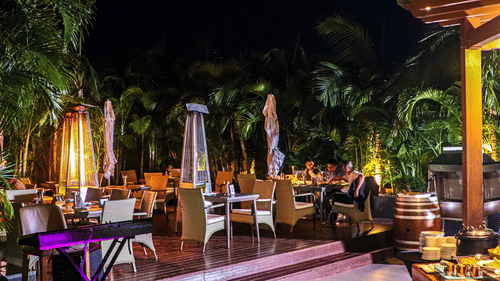 An outdoor deck with cozy seating and at Smoke House, Neelkanth Sarovar Premiere Lusaka