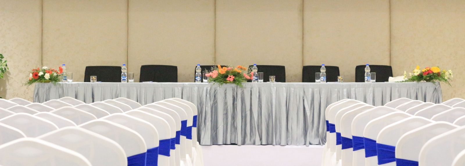 Central back view of a theatre style seating arrangement in a banquet hall at The Hamuse Hotel, Kodaikanal