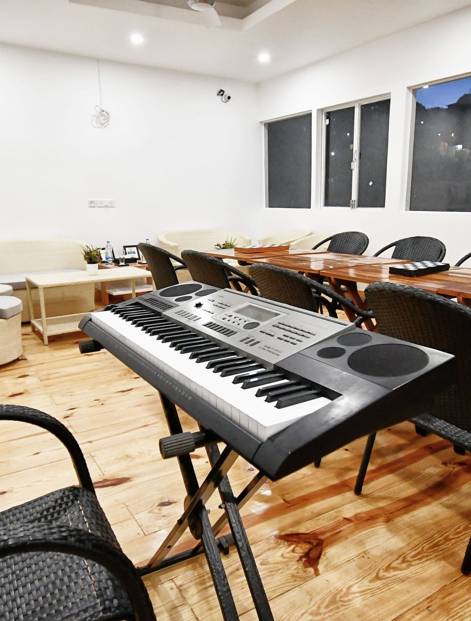 image of the karaoke set up in a room with chairs and tables set up at the tattva, joshimath