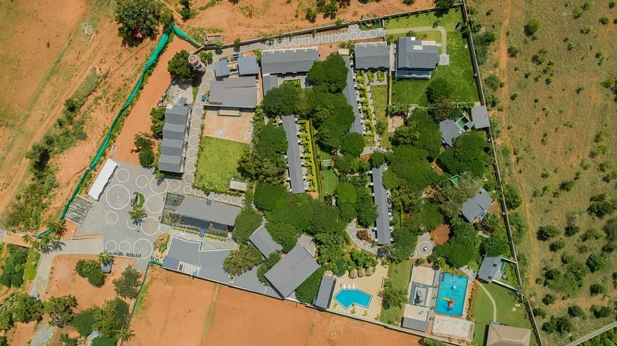 aerial view image of darza resorts featuring the entire property endowed with a lot of trees within the perimeter