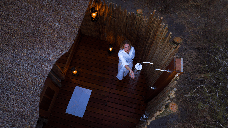 Aerial view of a starbed deck lit up at night in the Kalahari at Evolve Back resort