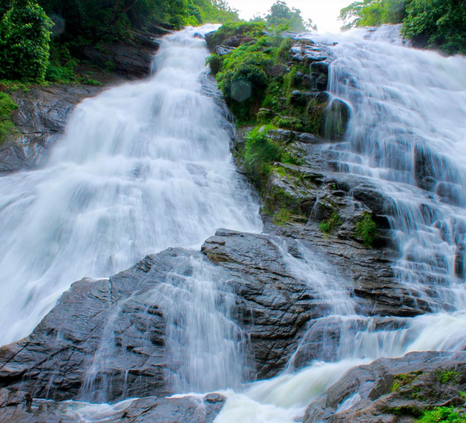 Water flows gently over a rocky slope.
