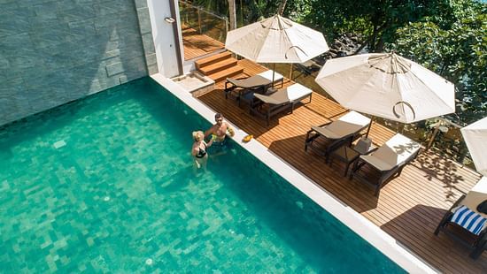 Image for Honeymoon Package for Beacon by the Bay Villas & Suites by The Clarks, Dondra featuring a couple in the swimming pool on a sunny day