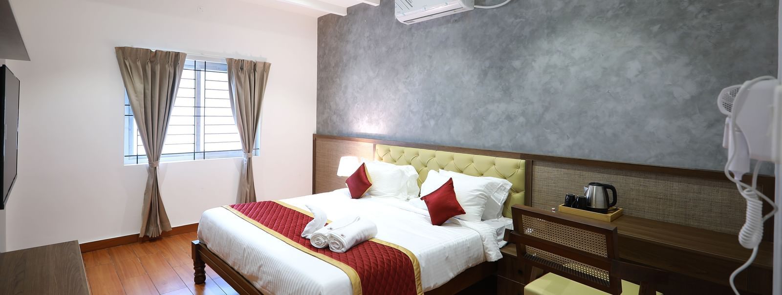 Full view of the Standard Room featuring a double bed with ample of natural light coming from the window beside it at WOW Naturefull Resorts, Yercaud.