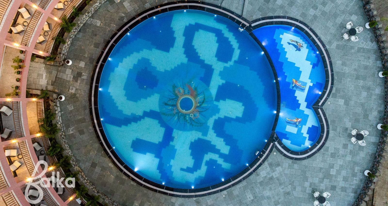 An aerial view of the Osian Valley Resort & Spa shows a central blue-tiled swimming pool.