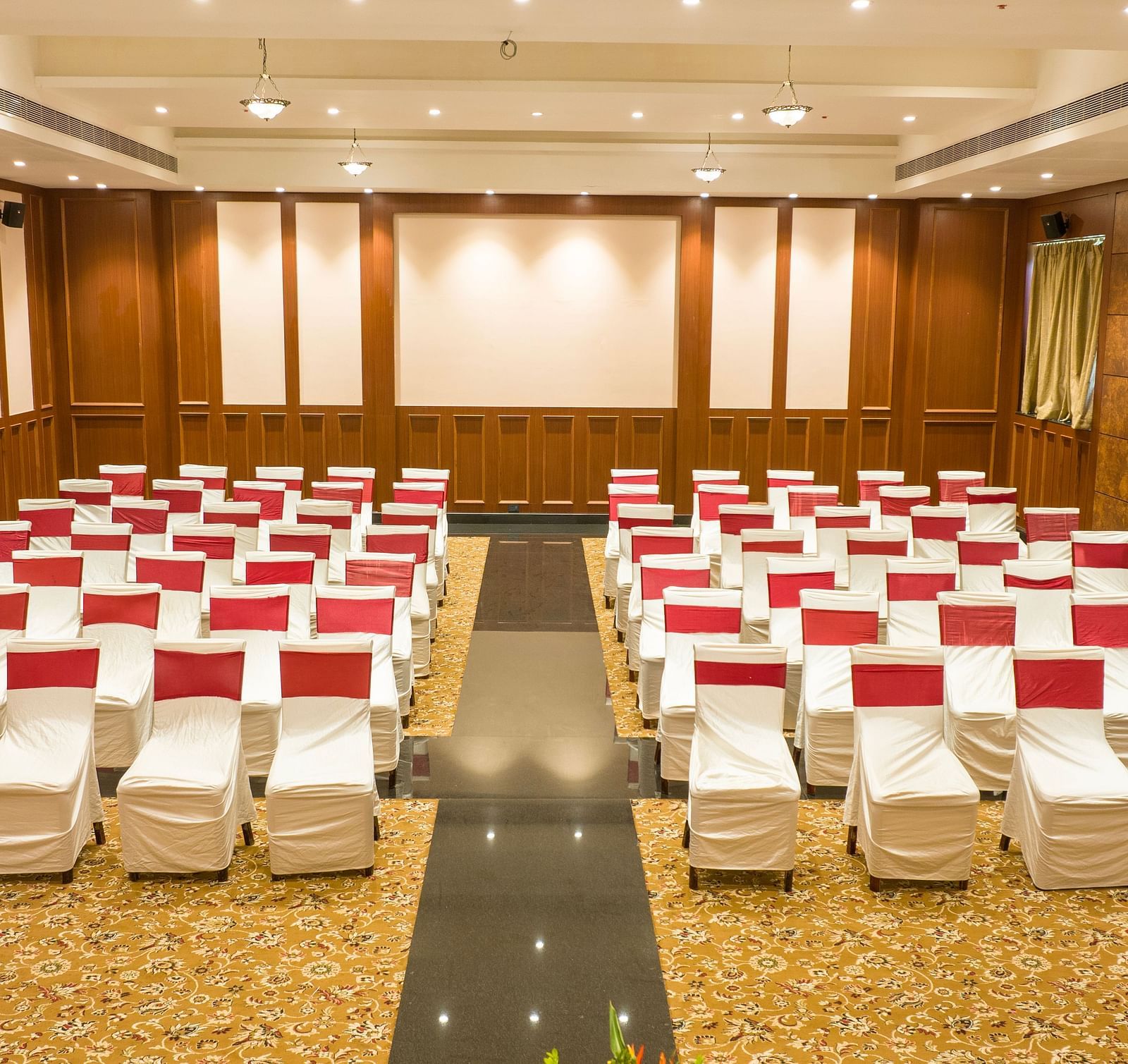 Conference/ Banquet room with neatly palced chairs at Ocean Spray Puducherry