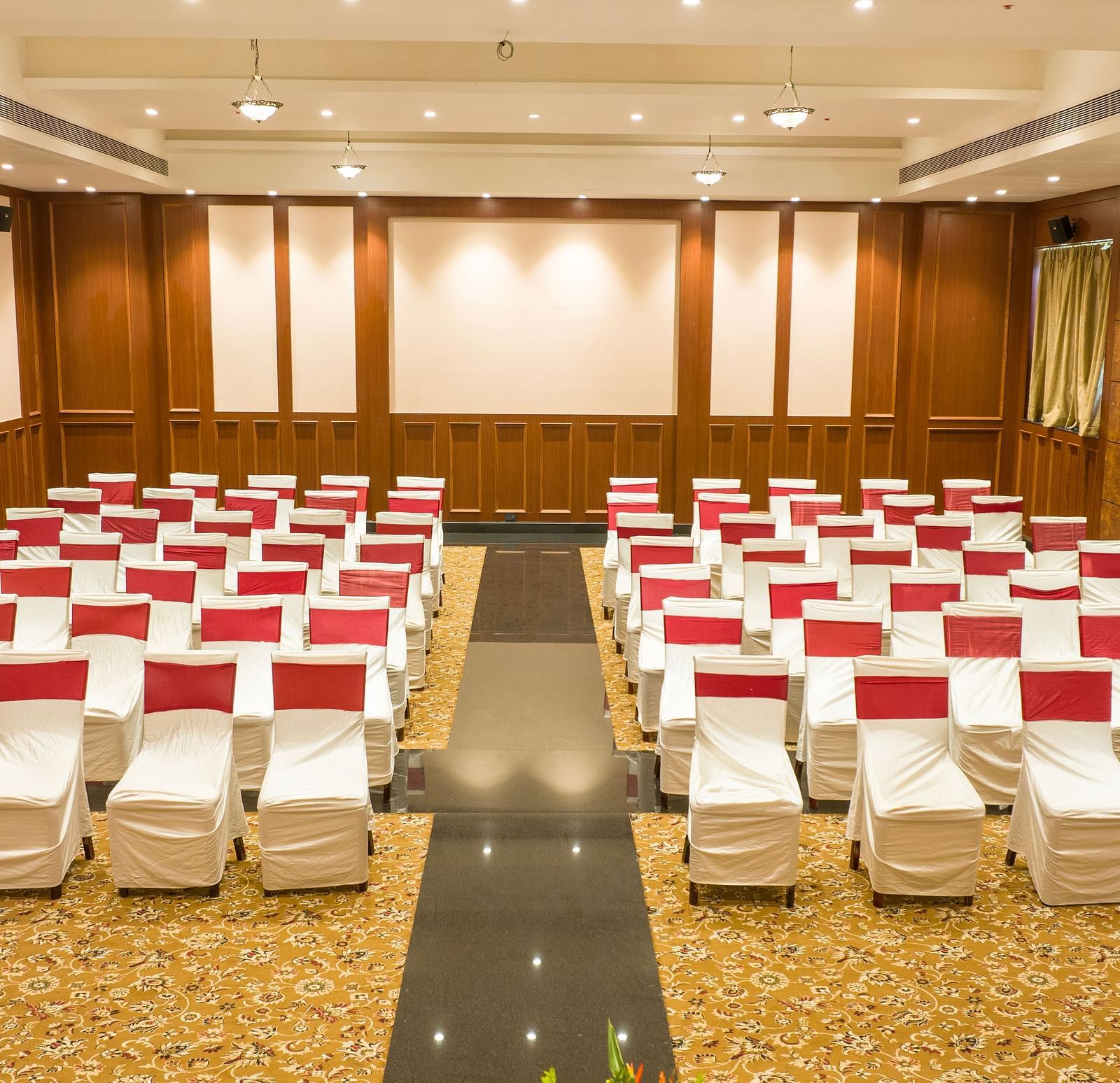 Conference/ Banquet room with neatly palced chairs at Ocean Spray Puducherry