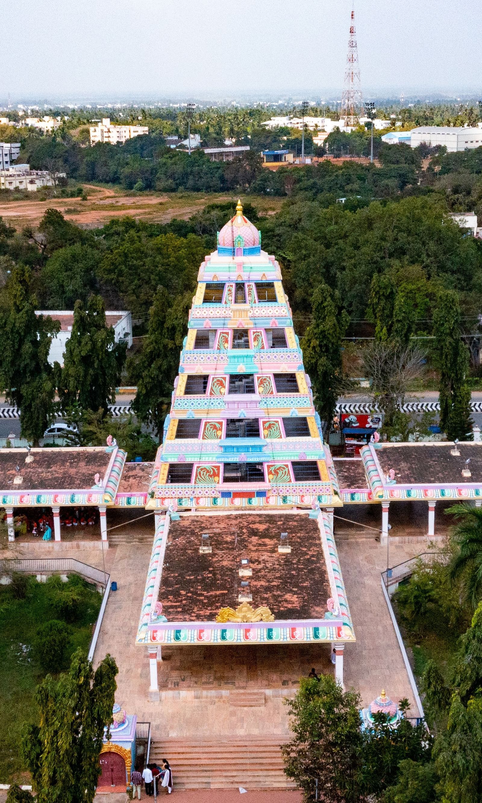 An image of the Manimandapam surrounded by greenery