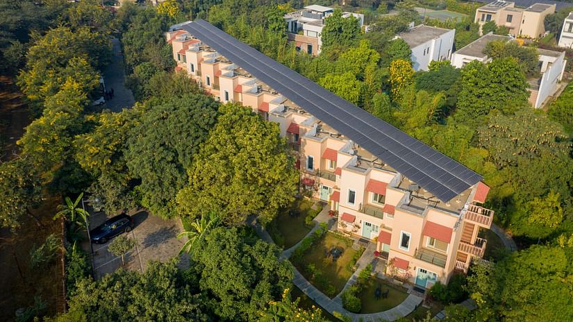 An aerial image of the Karma Chalet surrounded by lush greenery - Karma Lakelands.