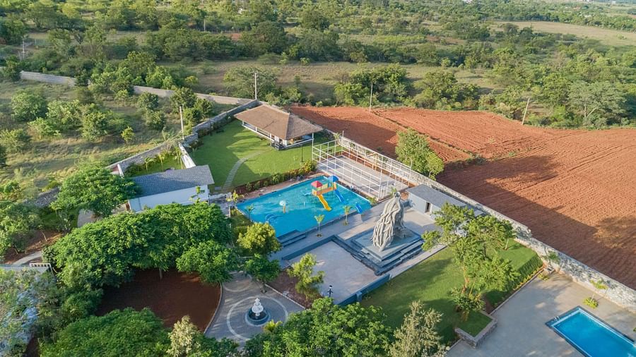 bird eye view image of the featuring the swimming pools and the lush greenery in and around - Darza Resorts