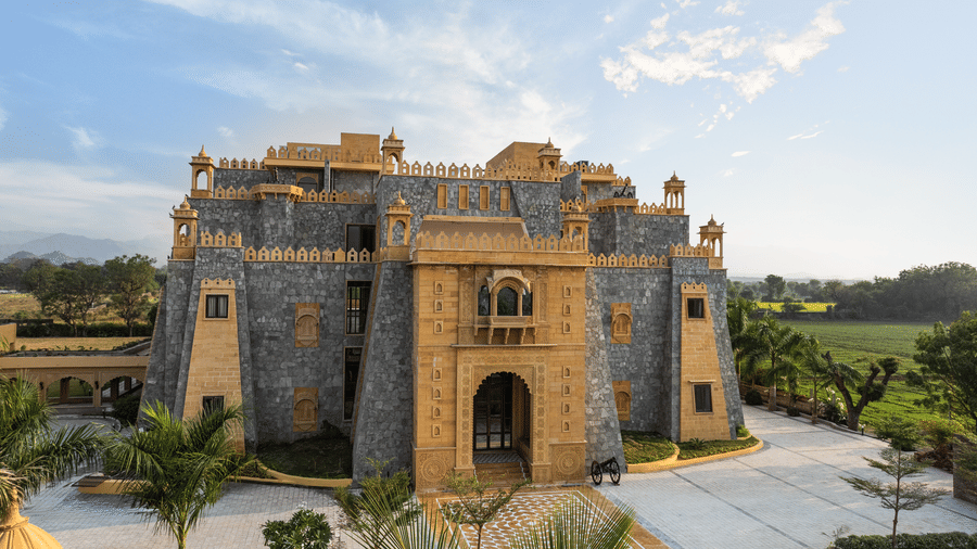 A front view of the main building of EsthereaRaj Leela, Ranakpur, featuring multiple levels and traditional architectural details.