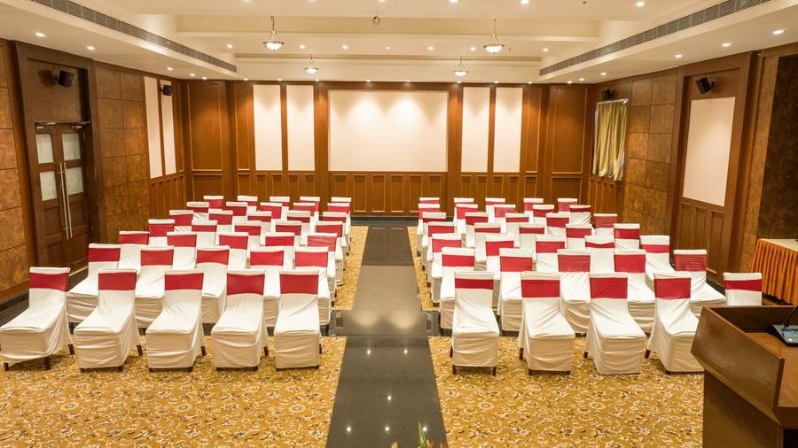 Conference/ Banquet room with neatly palced chairs at Ocean Spray Puducherry