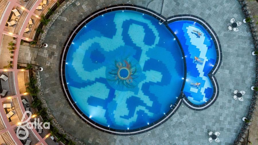 An aerial view of the Osian Valley Resort & Spa shows a central blue-tiled swimming pool.