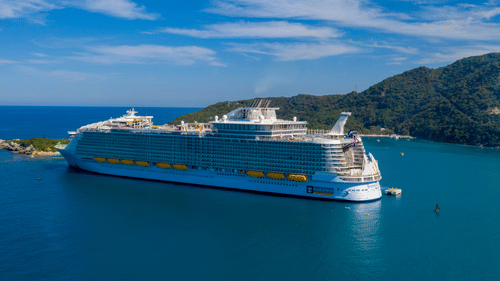 A large cruise ship docked near an island