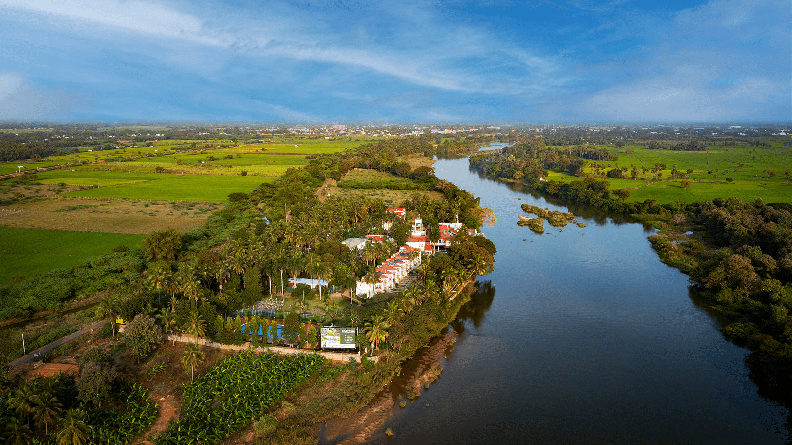 Aerial shot of the hotel surrounded by lush greenery - GReaT Trails River View Resort Thanjavur By GRT Hotels