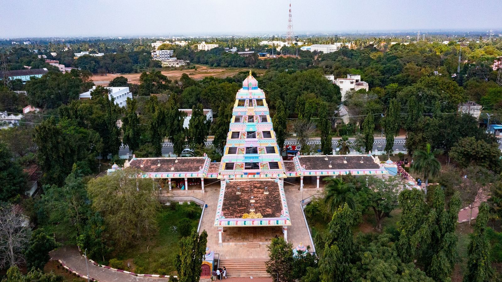 A view of the Manimandapam gracefully nestled amid lush greenery, offering a serene and scenic backdrop.