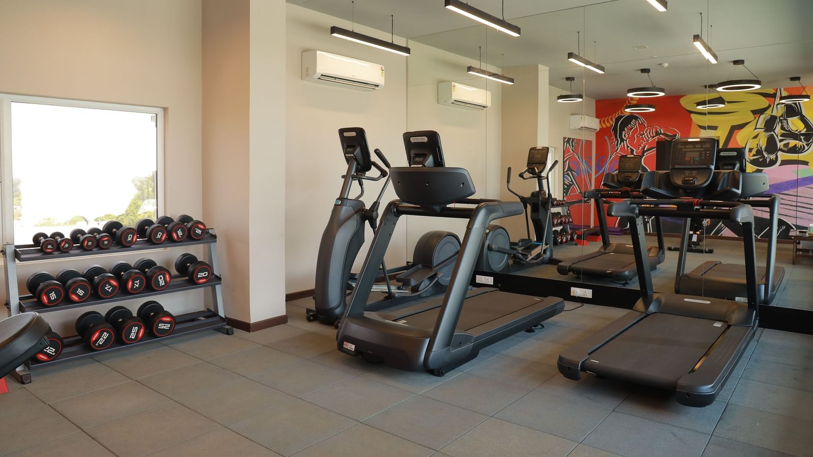 An image of our gym in Tuticorin with treadmills and a dumbbell rack - Regency Tuticorin by GRT Hotels