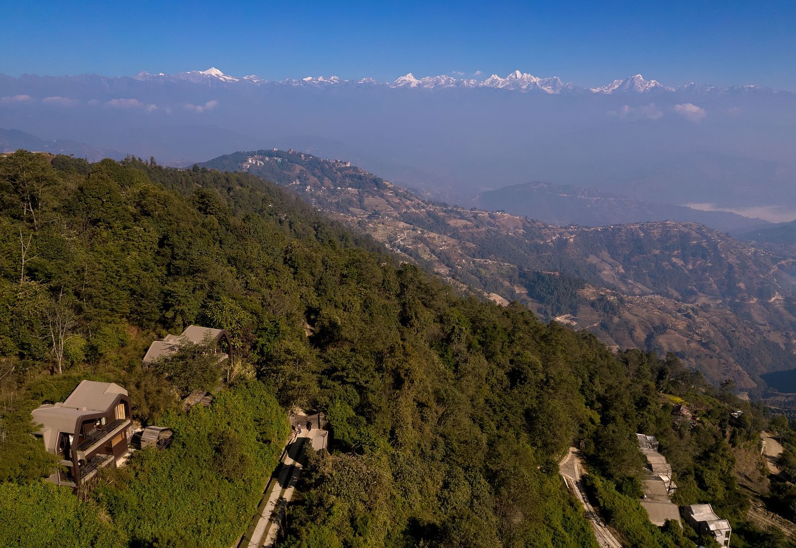 Panoramic view of a hilly landscape with scattered houses.