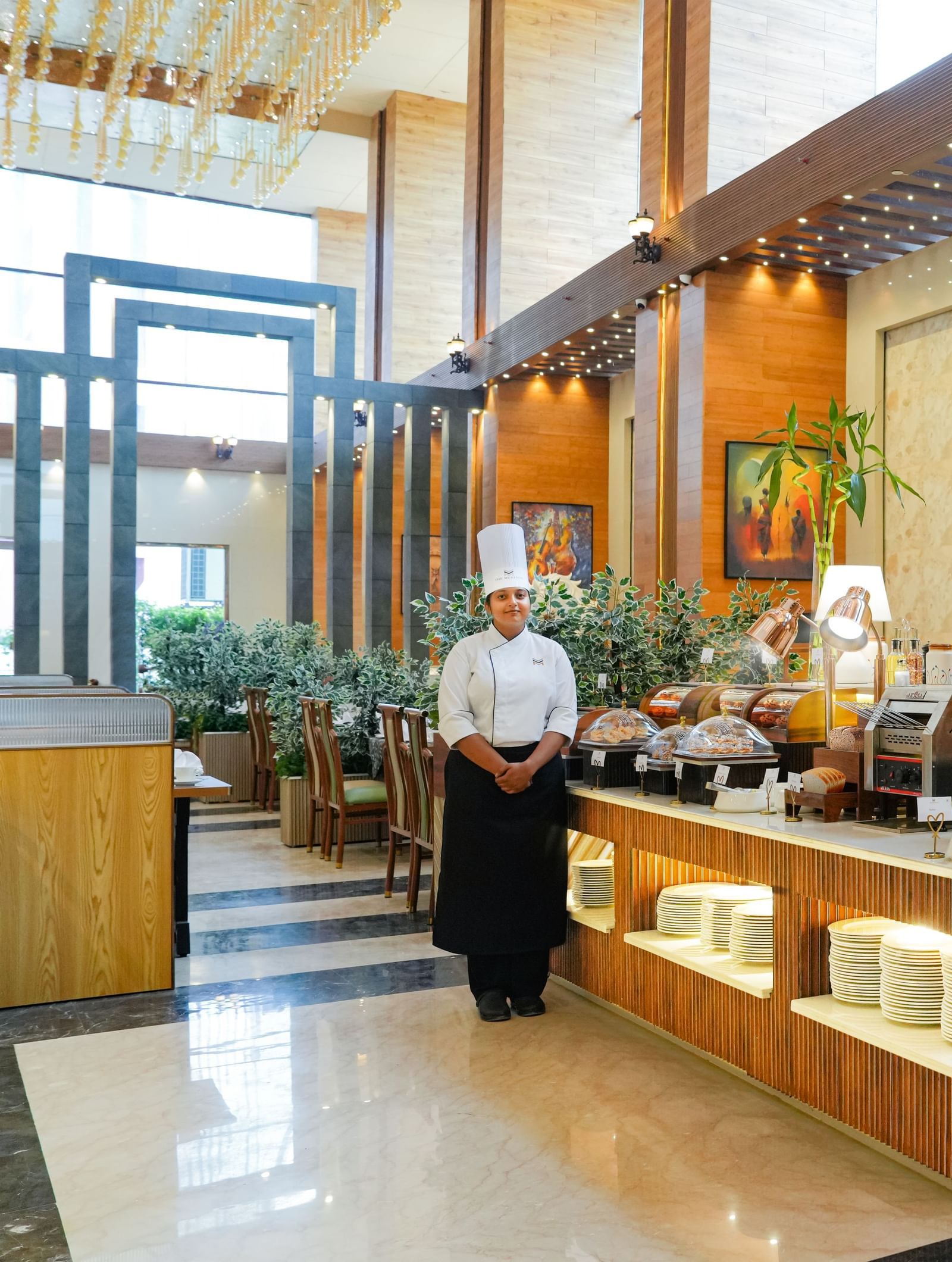Dining at The Meriton Hotels with bright lighting and elegant structures.