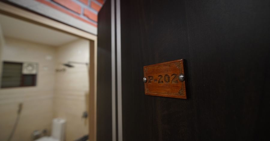 Door opening to room number '202' at GK Hill View Resort.