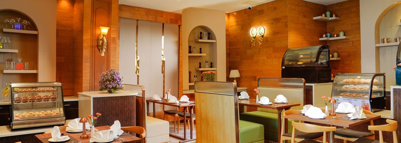 Corner view of the Lotus Cafe featuring a cosy ambience with well arranged dining tables at The Meriton.