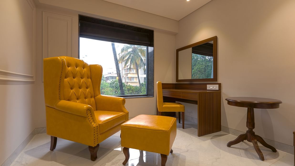 High Back Chairs and a table in a room with a window