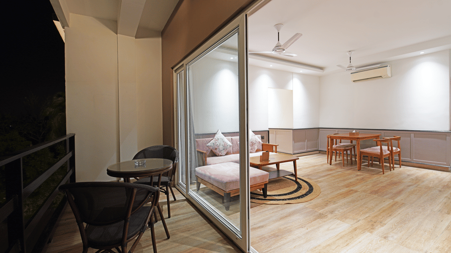The separate living room seen from the balcony that has an outdoor seating area in the Suite of Hotel Sonar Bangla, Kolaghat.