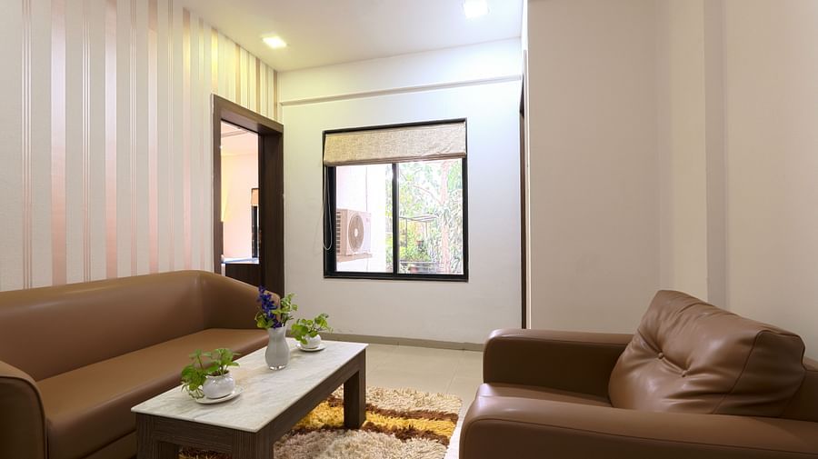 alt-text Picture featuring the interior of a living room with sofa and a table - Magnus Aerith Studio, Kharadi