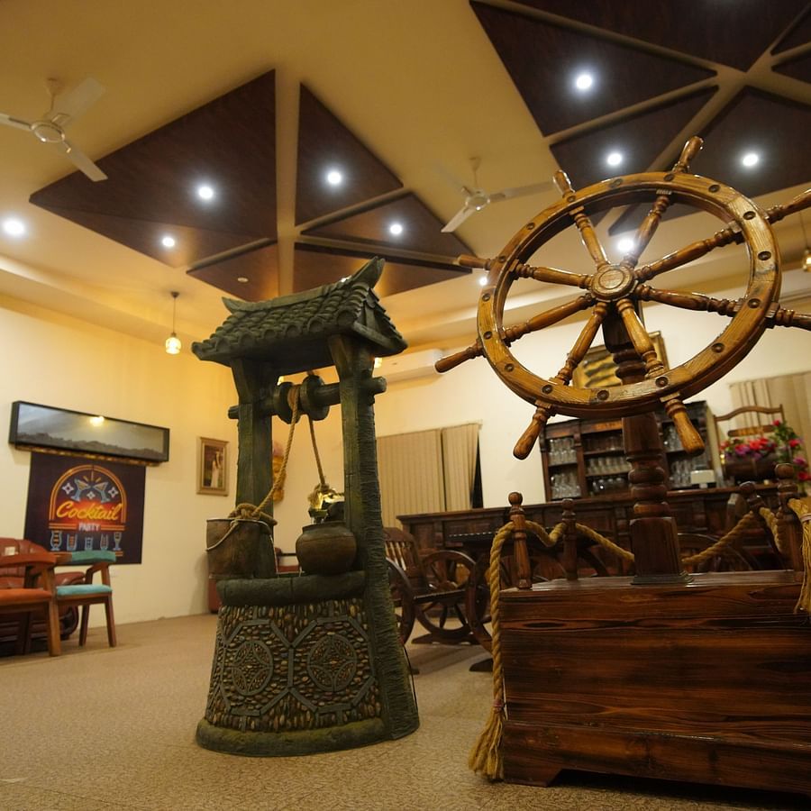 Bar of GK Hill View Resort furnished with cart-shaped furniture, ample lighting and intimate interior touches.