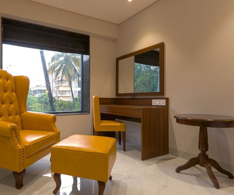 High Back Chairs and a table in a room with a window