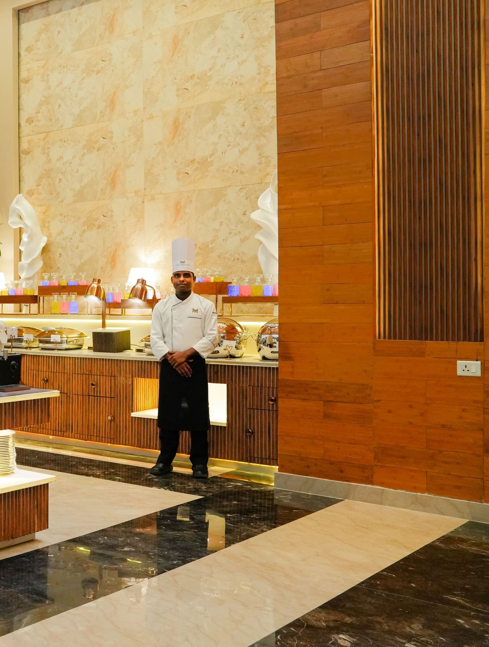 Dining at The Meriton Hotels with bright lighting and elegant structures.