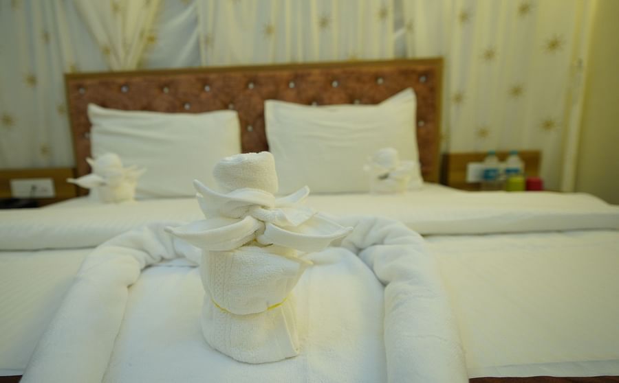 Close up of decorated turkey towels placed on the double bed of the Tent villa in GK Hill View Resort.