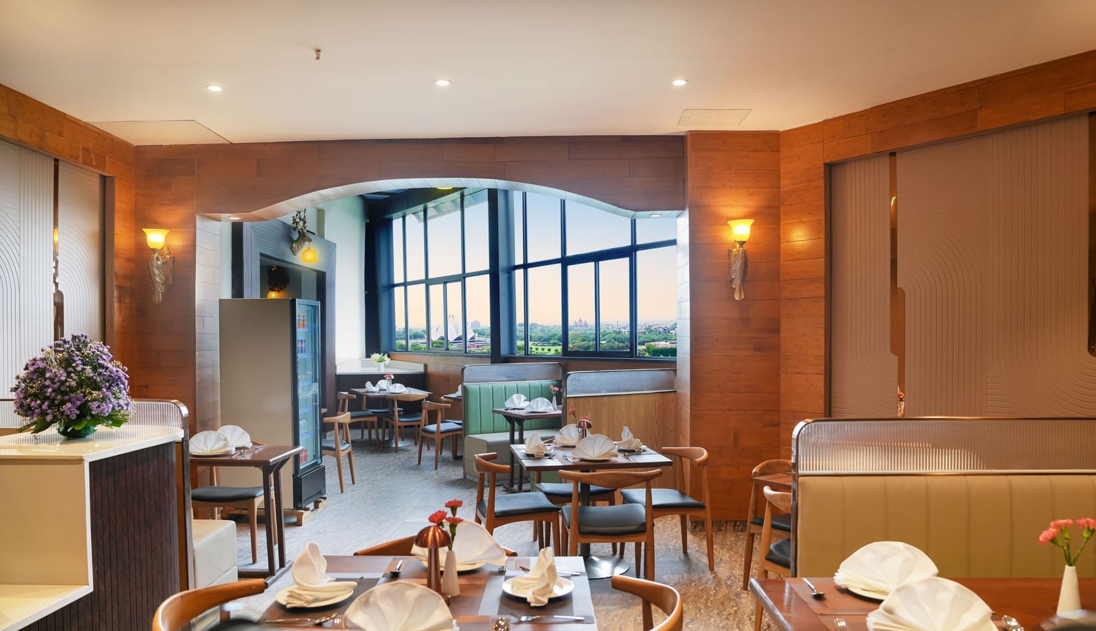 Full view of the Lotus Cafe at The Meriton featuring elegant interiors along with ample of natural light coming from the windows at the far end.