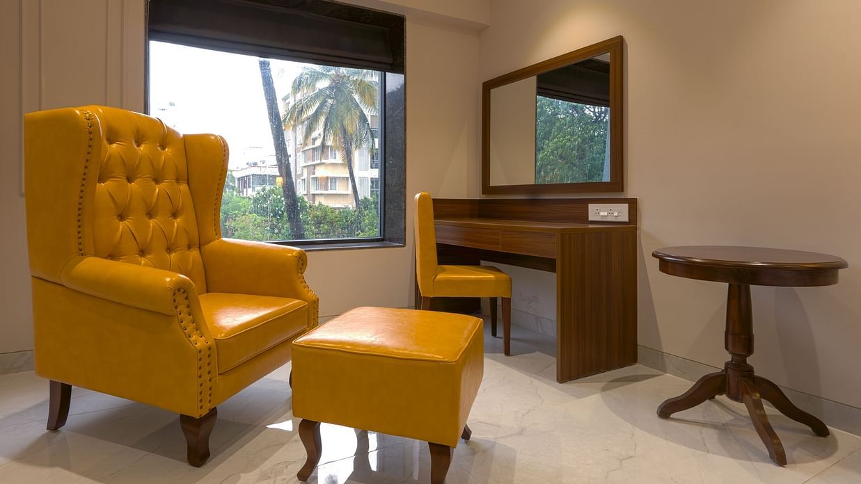 High Back Chairs and a table in a room with a window