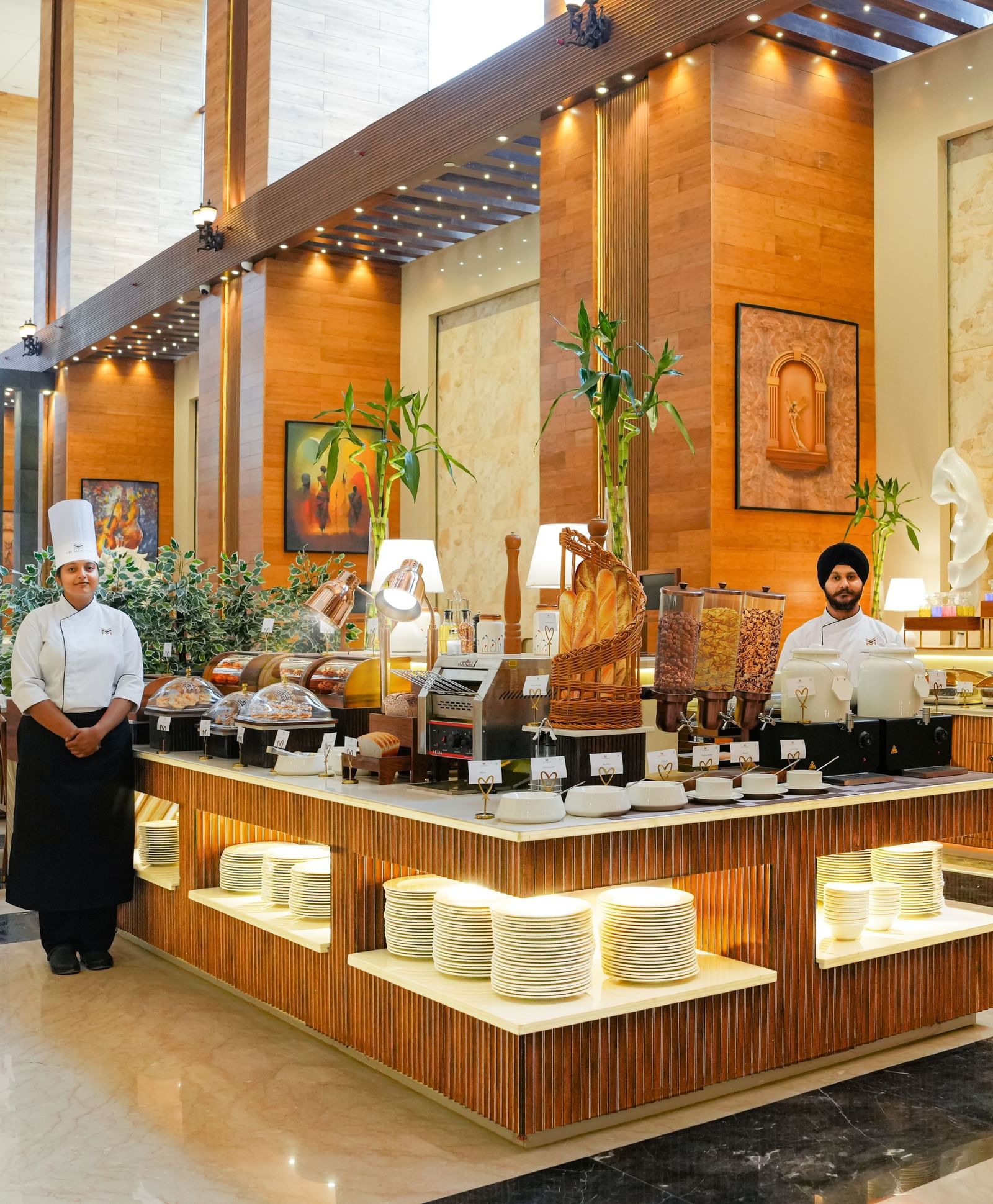 Dining at The Meriton Hotels with bright lighting and elegant structures.