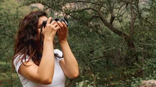 side-view-woman-taking-photos-nature