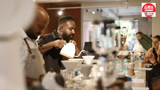 A barista in a dark outfit carefully pouring hot water over a coffee dripper at Unseen Boutique Hotel Assagao Goa with multiple brewing setups and guests visible in the background.