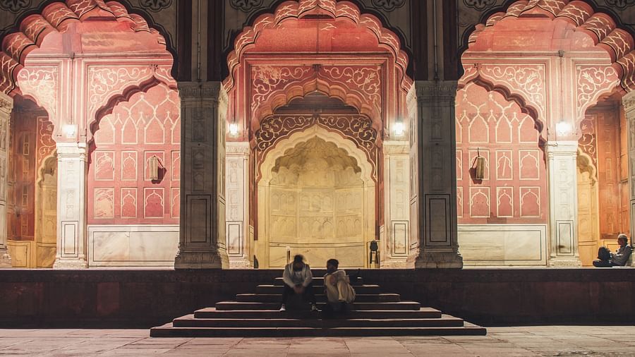 people sitting on the temple entrance with the temple in the background