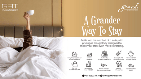 A guest relaxing in bed at Grand Madurai by GRT Hotels, showcasing complimentary meals, flexible stay, dining, wellness and travel benefits.