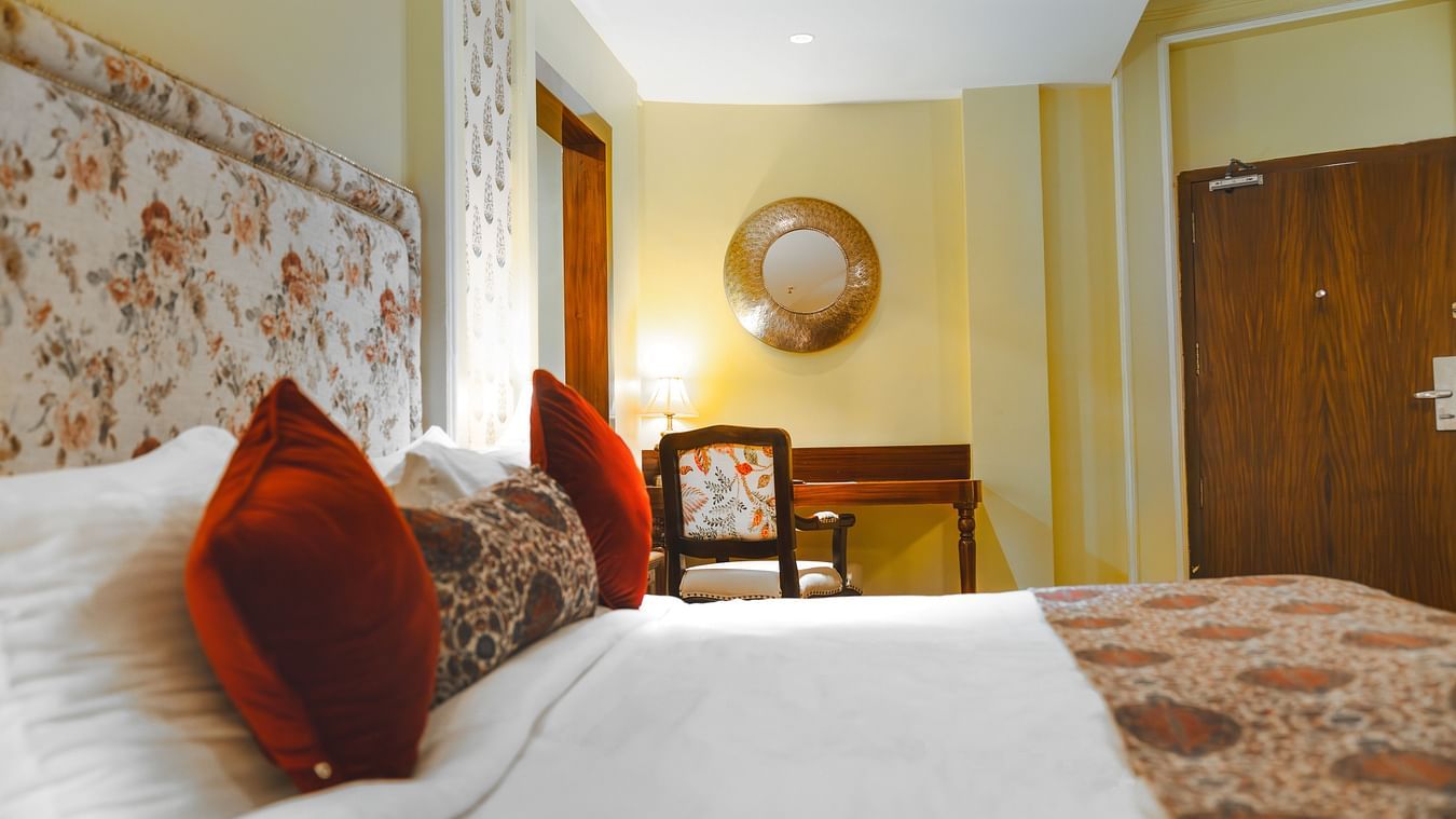 The king sized bed with red sleeping pillows at the Super deluxe room at The Garden Ananta Elite.