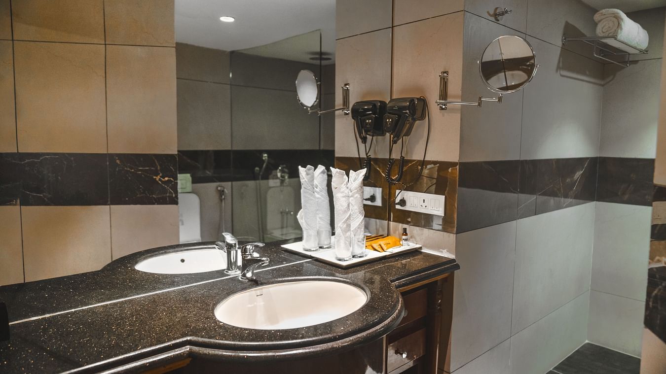 Washroom sink and accessories inside the Super deluxe room at The Garden Ananta Elite.