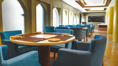 An image of seating area with sofa sets and a centre table placed in a room -  The Garden Ananta Elite, Rajkot