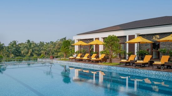 an image of a swimming pool with sun loungers at Cloud9 Sarovar Premiere, Palolem Goa