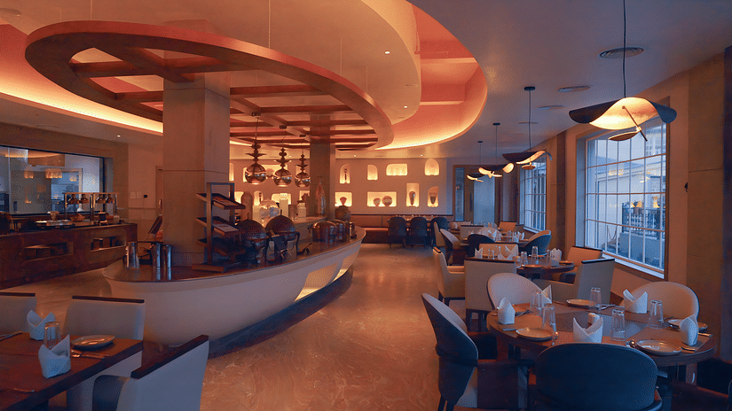 Image of Turquoise restaurant with seating area and lights on the ceiling at Voyage The Solitaire Bliss.