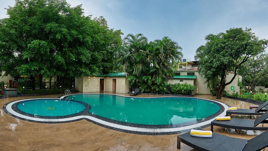 view of the pool and sun loungers at ABN Sarovar Portico, Jim Corbett